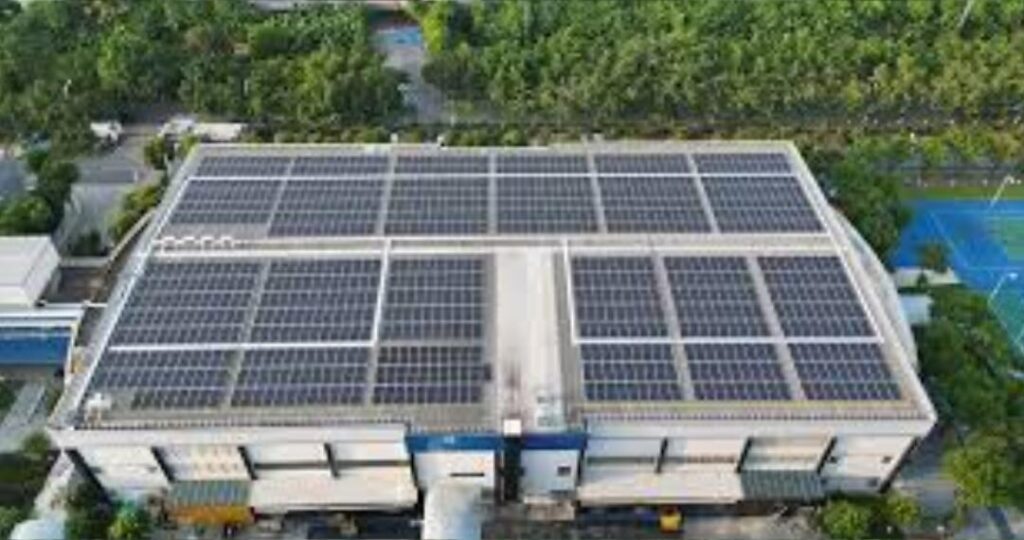 pic 3 an aerial view of a jabil inc. facility, highlighting green manufacturing practices, including solar panels and eco friendly production lines.